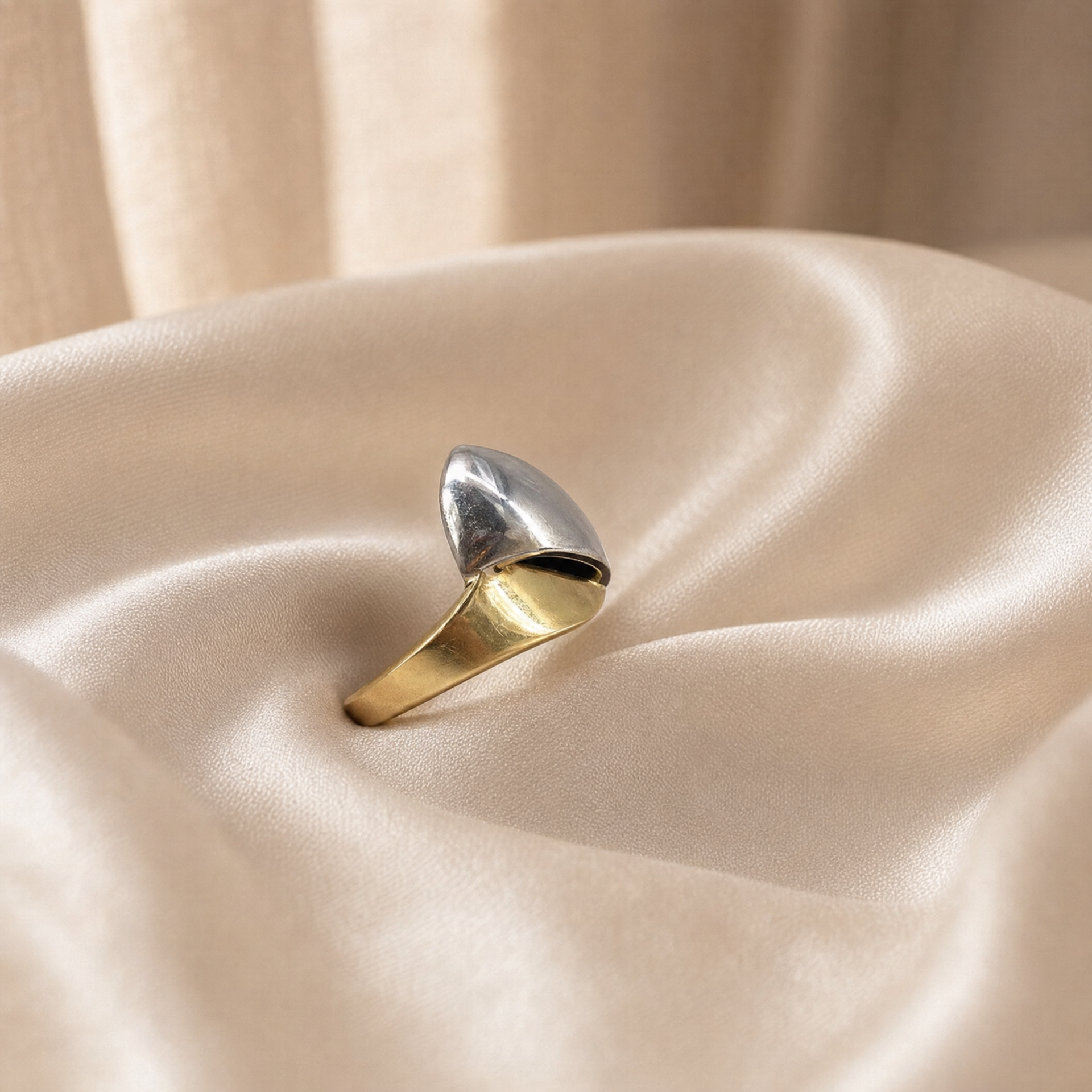 The Orbit 18K multi-tone gold sculptural ring on ivory satin